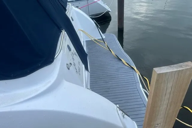 Slide: The Image of 2006 Maxum 3300 SE boat docked with blue cover and power cable. - 4
