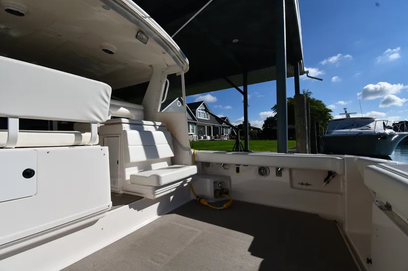 Slide: The Image of 2004 Tiara Yachts 3500 Open, docked with spacious seating and scenic waterfront view. - 17