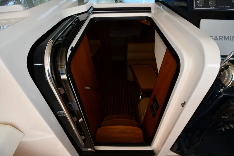 Slide: The Image of 2004 Tiara Yachts 3500 Open cabin entrance with wooden interior and seating area. - 24