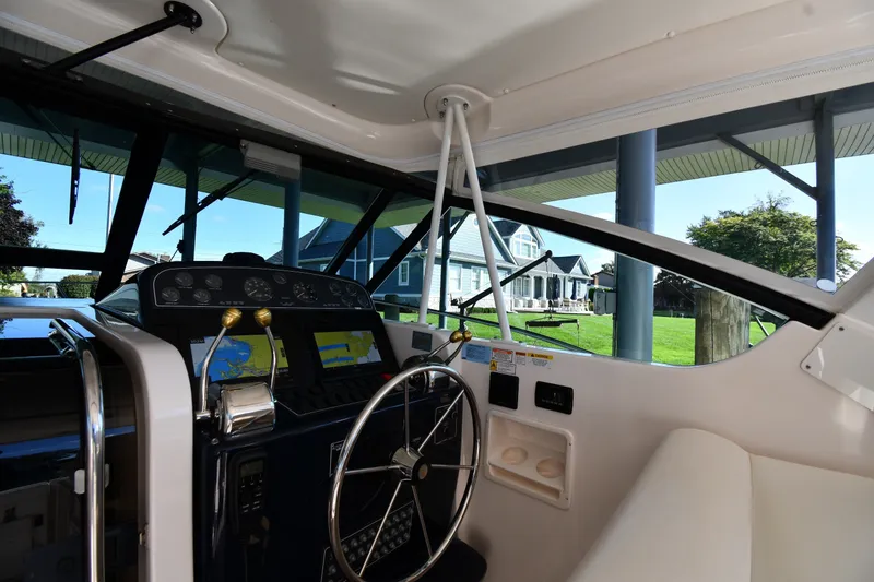 Slide: The Image of 2004 Tiara Yachts 3500 Open helm with navigation equipment and steering wheel. - 9