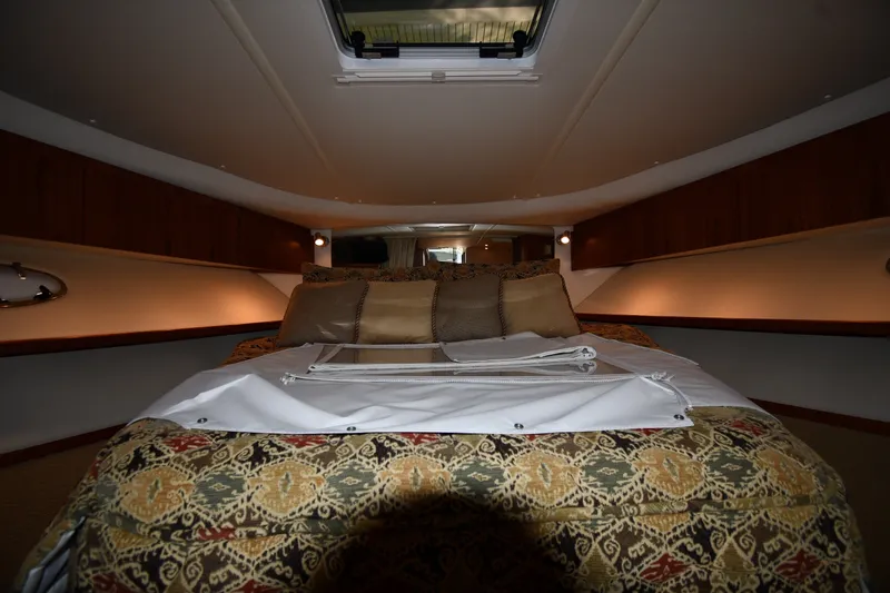 Slide: The Image of Luxurious cabin interior of 2004 Tiara Yachts 3500 Open with elegant bedding. - 26