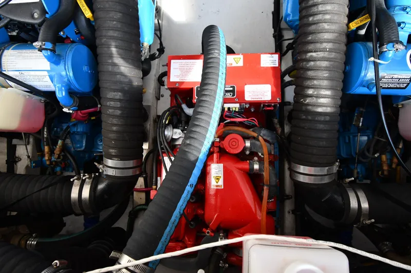 Slide: The Image of Engine compartment of a 2004 Tiara Yachts 3500 Open, featuring hoses and components. - 49
