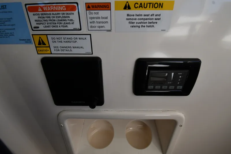Slide: The Image of Control panel and warning labels on a 2004 Tiara Yachts 3500 Open. - 11