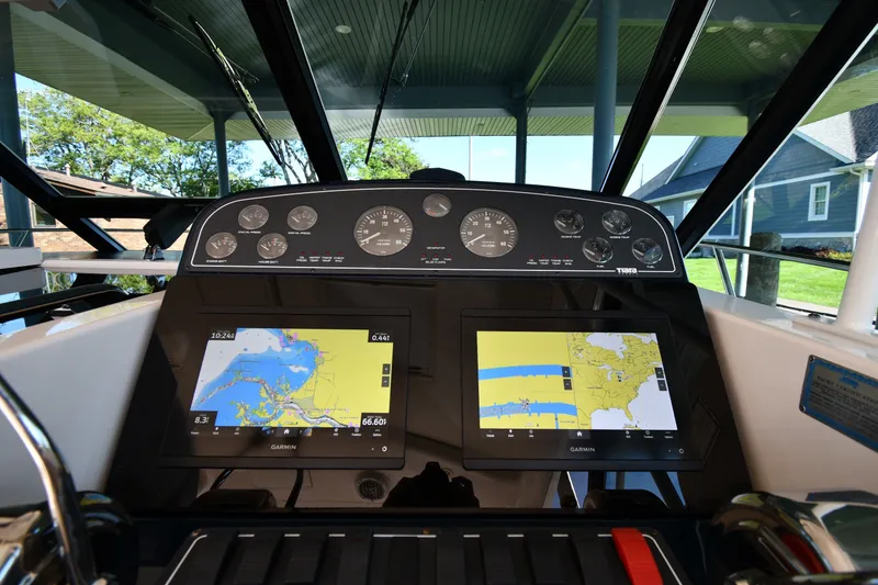 Slide: The Image of Dashboard of a 2004 Tiara Yachts 3500 Open with navigation screens and gauges. - 10