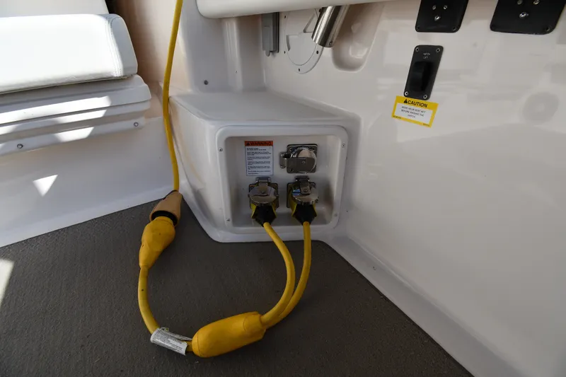 Slide: The Image of Electrical connections on a 2004 Tiara Yachts 3500 Open boat, featuring yellow power cords. - 23