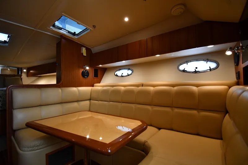 Slide: The Image of Luxurious interior of 2004 Tiara Yachts 3500 Open with plush seating and wooden table. - 31