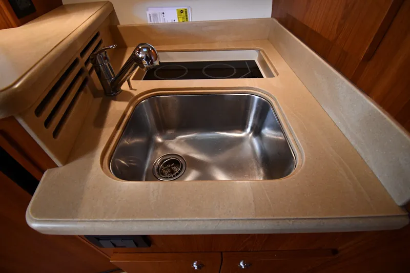 Slide: The Image of 2004 Tiara Yachts 3500 Open kitchen sink with modern faucet and stovetop. - 36