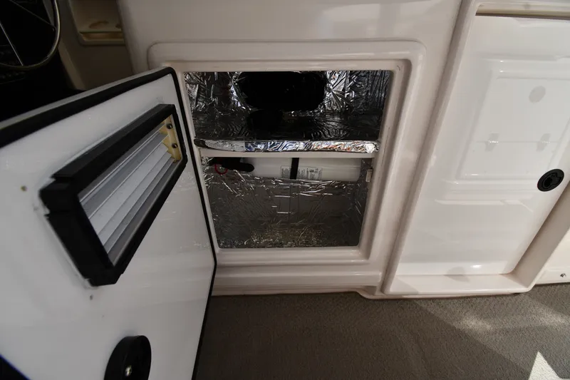 Slide: The Image of 2004 Tiara Yachts 3500 Open interior storage compartment with insulation. - 22