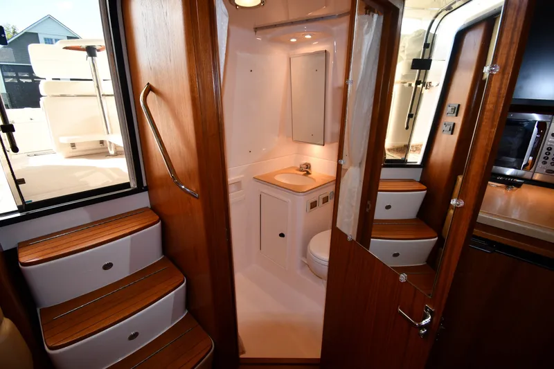 Slide: The Image of 2004 Tiara Yachts 3500 Open interior with wooden stairs and compact bathroom. - 40