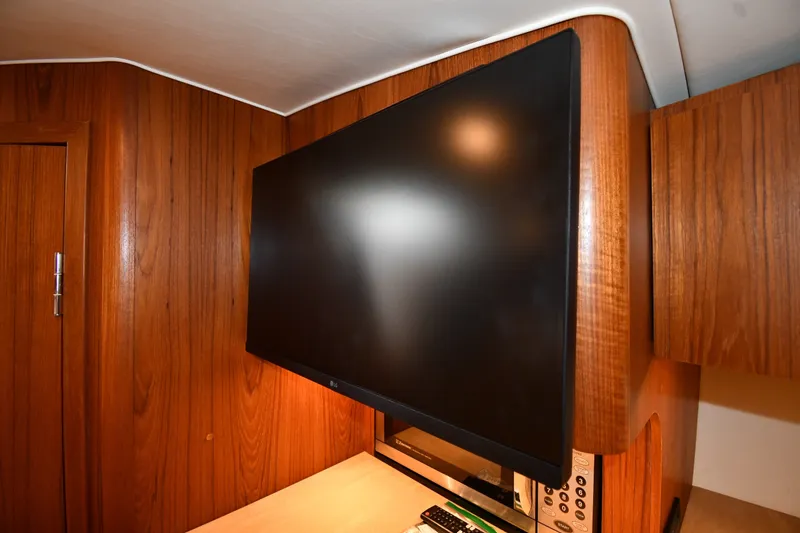 Slide: The Image of Flat-screen TV in 2004 Tiara Yachts 3500 Open, wooden interior detail. - 38