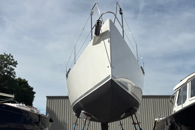 Slide: The Image of A 2012 J Boats J/111 is on a stand. The hull is white and shiny. - 1
