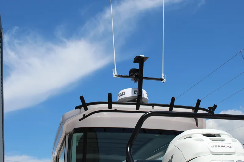 Slide: The Image of 2022 Axopar 37 XC Cross Cabin Brabus with radar and antenna against blue sky. - 17
