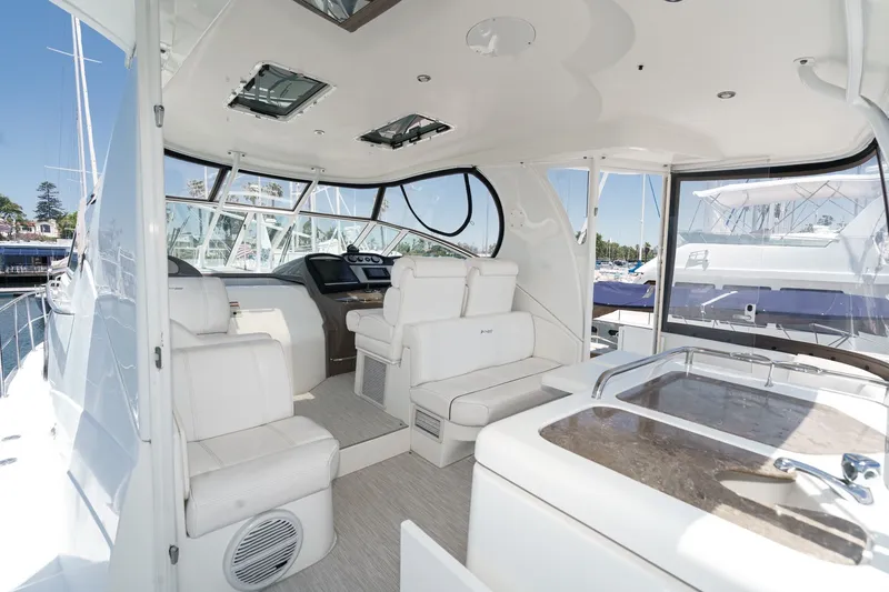Slide: The Image of 2008 Cruisers Yachts 415 Express Motoryacht interior with white seating and helm station. - 20