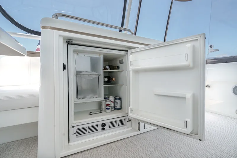 Slide: The Image of Open mini fridge on 2008 Cruisers Yachts 415 Express Motoryacht, stocked with beverages. - 25
