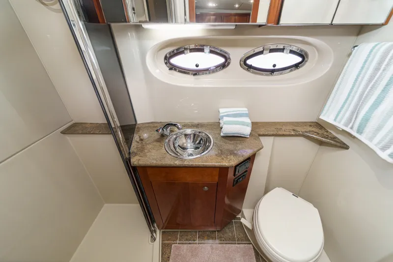 Slide: The Image of Luxurious bathroom in 2008 Cruisers Yachts 415 Express Motoryacht with sink and porthole windows. - 57