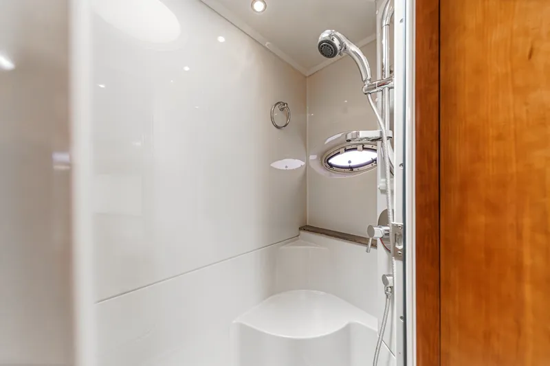 Slide: The Image of Shower area in 2008 Cruisers Yachts 415 Express Motoryacht with modern fixtures and porthole window. - 56