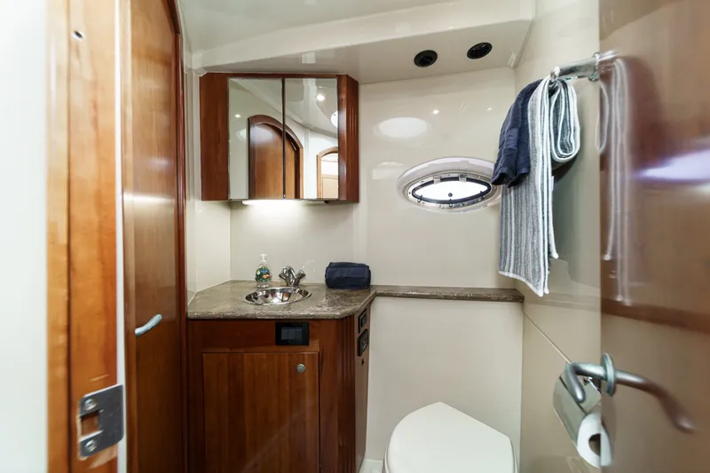 Slide: The Image of Luxurious bathroom in 2008 Cruisers Yachts 415 Express Motoryacht with wood cabinetry and porthole. - 52