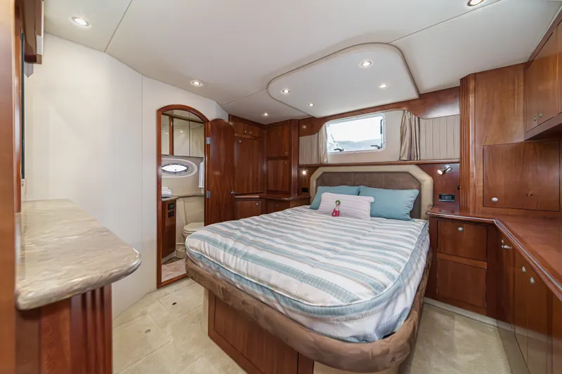 Slide: The Image of Luxurious 2008 Cruisers Yachts 415 Express Motoryacht bedroom with elegant wood cabinetry. - 55
