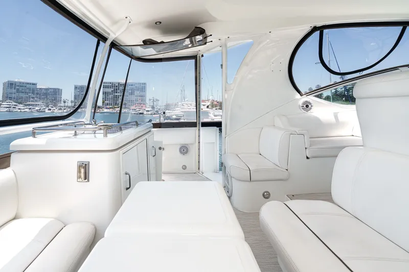 Slide: The Image of Luxurious interior of 2008 Cruisers Yachts 415 Express Motoryacht with white seating and marina view. - 27