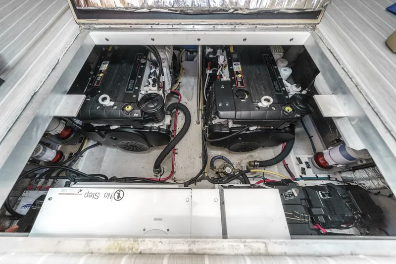 Slide: The Image of Engine compartment of 2008 Cruisers Yachts 415 Express Motoryacht, showcasing dual engines and components. - 62