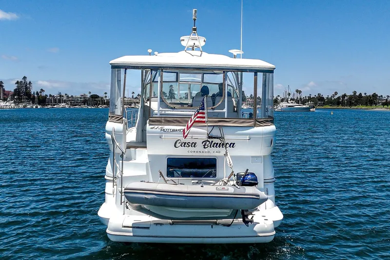 Slide: The Image of 2008 Cruisers Yachts 415 Express Motoryacht on water, rear view with American flag. - 6