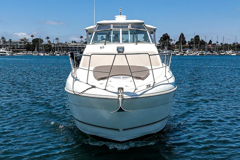 Slide: The Image of 2008 Cruisers Yachts 415 Express Motoryacht on calm water, marina in background. - 7