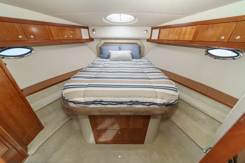 Slide: The Image of Luxurious cabin interior of 2008 Cruisers Yachts 415 Express Motoryacht with cozy bed and wood accents. - 49