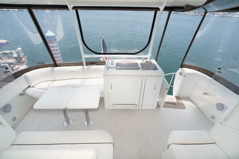 Slide: The Image of Luxurious 2008 Cruisers Yachts 415 Express Motoryacht interior with seating and kitchenette overlooking water. - 22