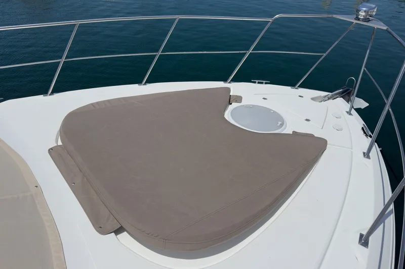 Slide: The Image of 2008 Cruisers Yachts 415 Express Motoryacht bow with cushioned sunpad and railing. - 18