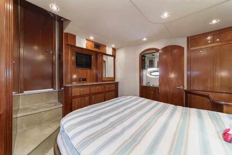 Slide: The Image of Luxurious 2008 Cruisers Yachts 415 Express Motoryacht interior with wood cabinetry and cozy bedroom. - 59