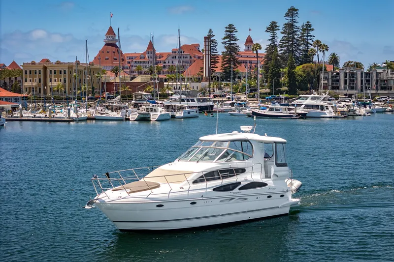 Slide: The Image of 2008 Cruisers Yachts 415 Express Motoryacht cruising near a scenic marina backdrop. - 1