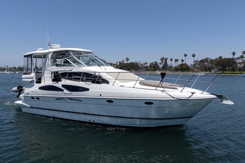 Slide: The Image of 2008 Cruisers Yachts 415 Express Motoryacht on calm water, clear sky background. - 13