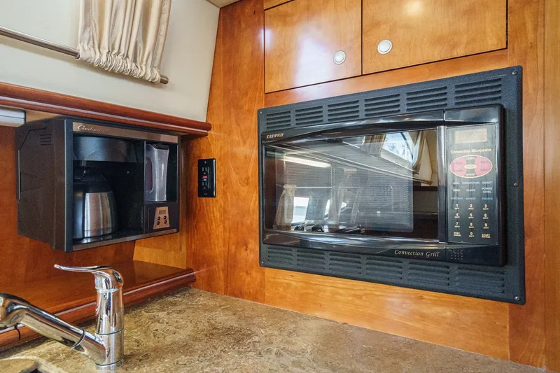 Slide: The Image of 2008 Cruisers Yachts 415 Express Motoryacht kitchen with microwave and coffee maker. - 42