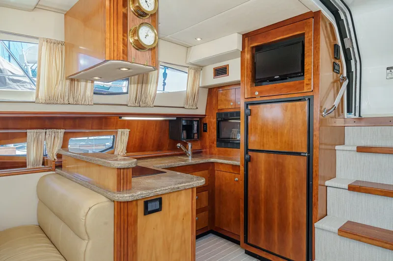 Slide: The Image of Luxurious 2008 Cruisers Yachts 415 Express Motoryacht interior with wood cabinetry and modern amenities. - 38