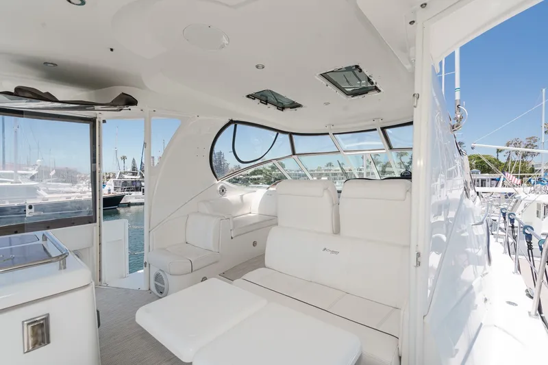 Slide: The Image of Luxurious 2008 Cruisers Yachts 415 Express Motoryacht interior with white seating and marina view. - 23
