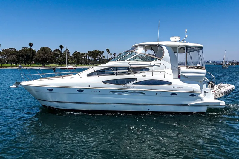 Slide: The Image of 2008 Cruisers Yachts 415 Express Motoryacht on serene blue water, clear sky backdrop. - 3