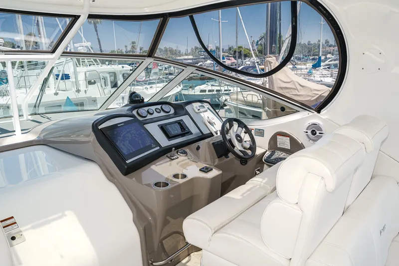 Slide: The Image of 2008 Cruisers Yachts 415 Express Motoryacht helm with modern controls and plush seating. - 33