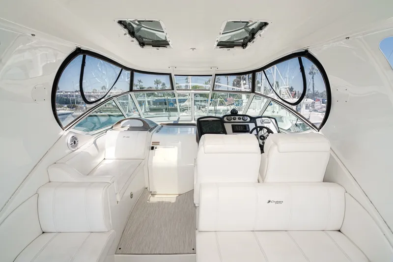 Slide: The Image of 2008 Cruisers Yachts 415 Express Motoryacht cockpit with white seating and modern controls. - 26