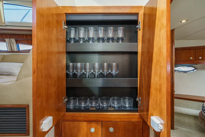 Slide: The Image of Wooden cabinet with glassware inside a 2008 Cruisers Yachts 415 Express Motoryacht. - 48