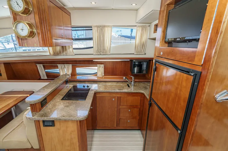 Slide: The Image of Luxurious 2008 Cruisers Yachts 415 Express Motoryacht kitchen with wood cabinetry and modern appliances. - 40