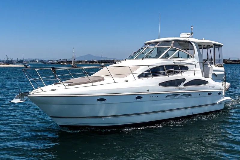 Slide: The Image of 2008 Cruisers Yachts 415 Express Motoryacht on calm blue water under clear sky. - 2