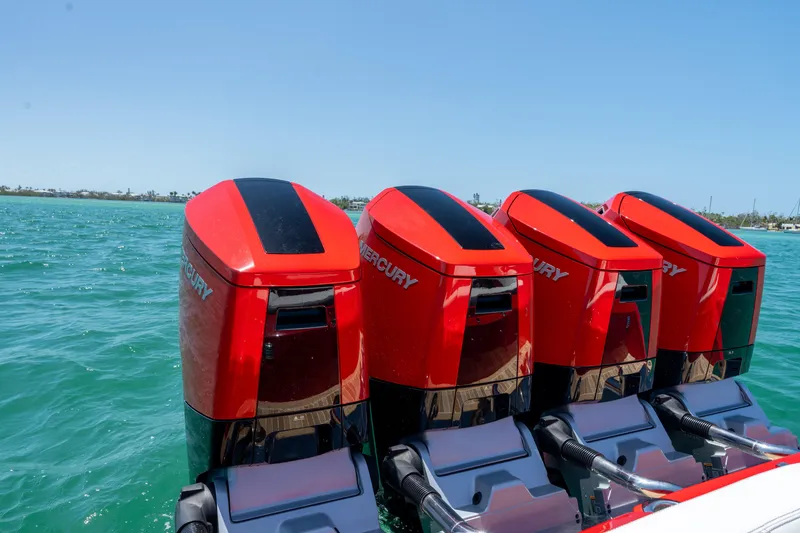 Slide: The Image of Four red Mercury outboard engines on a 2023 Nor-Tech 55 Flyer boat. - 24