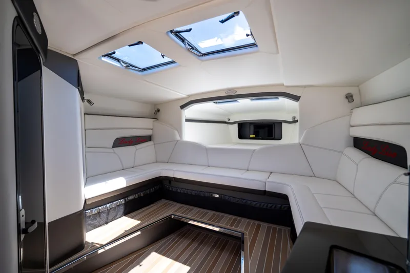 Slide: The Image of Luxurious interior of 2023 Nor-Tech 55 Flyer boat with sleek white seating and skylights. - 48