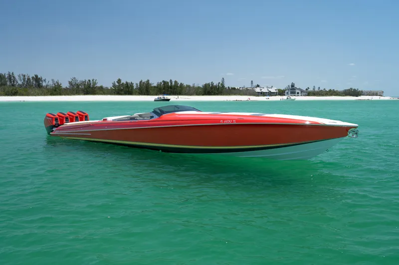 Slide: The Image of 2023 Nor-Tech 55 Flyer boat in vibrant red on turquoise water near a sandy beach. - 14