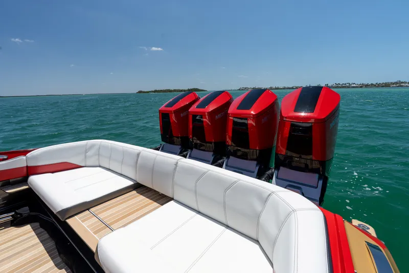 Slide: The Image of 2023 Nor-Tech 55 Flyer boat with four powerful outboard engines on open water. - 26