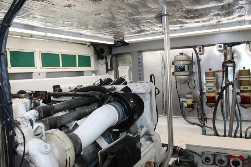 Slide: The Image of Engine room of 2003 Ocean Yachts 65 Odyssey, showcasing mechanical components and systems. - 103