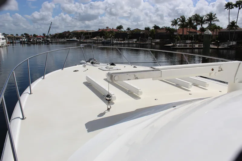 Slide: The Image of 2003 Ocean Yachts 65 Odyssey yacht deck with marina view under cloudy sky. - 24