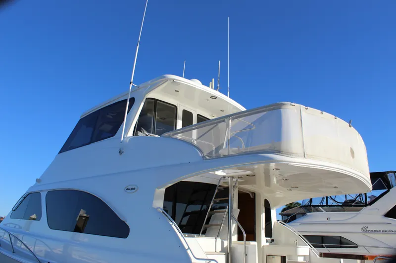 Slide: The Image of 2003 Ocean Yachts 65 Odyssey, luxury yacht with sleek design against clear blue sky. - 19