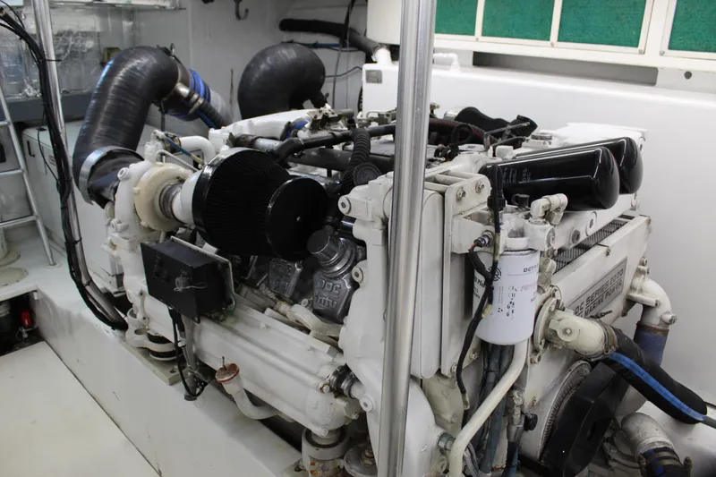 Slide: The Image of Engine room of 2003 Ocean Yachts 65 Odyssey, showcasing powerful marine engine components. - 98