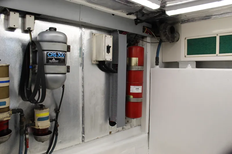 Slide: The Image of Engine room of 2003 Ocean Yachts 65 Odyssey with coolant recovery system and fire extinguisher. - 108